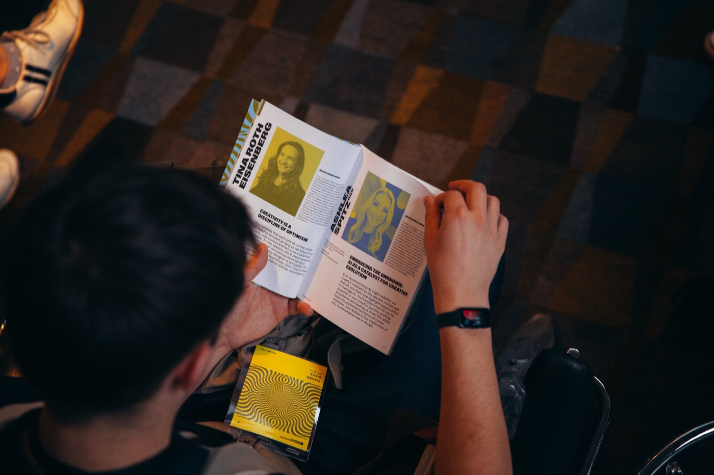 An attendee reading Ashlea’s speaker page in the Design Thinkers 2024 program